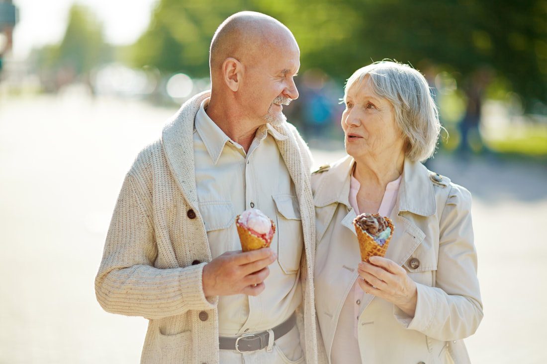 elderly couple enjoying ice cream